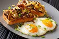 Shiitake mushroom and cheddar toasts with fried eggs close-up on a plate. horizontal