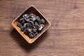 Shiitake mushroom snack in a wooden bowl isolated on a wooden table. Royalty Free Stock Photo