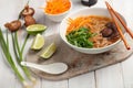 Shiitake and soba soup with carrot and green onion