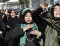 Shiite Muslim women hold up their chained hands. Royalty Free Stock Photo