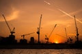 Shillouette contruction and cranes beside the Rive Royalty Free Stock Photo