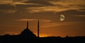 Shilouette of a mosque with dome and minaret in the evening sky with detailed full moon composite. Elements of this image