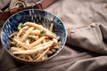 Shimeji mushrooms in a bowl on grey chef`s apron background. Pickled japanese brown beech or buna shimeji. Umami taste Royalty Free Stock Photo