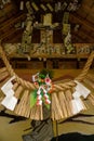 Shimenawa, shide, and paper seals on roof of roadside Shinto shrine, Takachiho, Japan