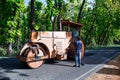 Road roller at road construction site, Worker on a road construction, Street