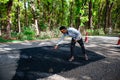 Worker on a road construction, Street resurfacing. Fresh asphalt construction.