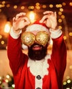 Shimmering balls christmas decorations. Bearded man Santa Claus decorating christmas tree with golden decorations. Sale Royalty Free Stock Photo