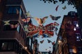 Shimmering Carnaby sign surrounded by butterflies on Carnaby Street, London, UK