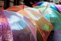 shimmering, colorchanging umbrellas for sale on a rainy day