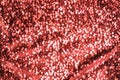 Shimmering festive background texture of shiny coral defocus