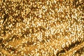 Shimmering festive background texture of shiny gold color defocus