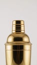 A shimmering golden cocktail shaker midpour Royalty Free Stock Photo