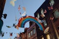 Shimmering hanging rainbow sign surrounded by butterflies on Carnaby Street, London, UK