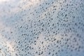 Shimmering raindrops on car surface. Reflected sky. Abstract background. Selective photo Royalty Free Stock Photo