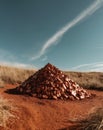 Shimmering Raw Copper Ore Mound in Natural Landscape Under Clear Sky Royalty Free Stock Photo