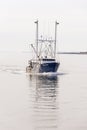 Shimmering reflection of scalloper Virginia Dare on calm October morning on the Acushnet River