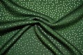 shimmering silver polka dots pattern on green fashion cloth