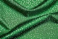 shimmering silver polka dots pattern on green fashion cloth