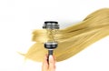 Shine long blond hair with round brush after Spa treatment. Curls of hair. Wavy long curly hair. Hair extensions, materials and