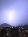 Shine and thunderstorm above mountain and city