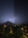 Shine and thunderstorm above mountain and city