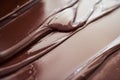 Shiney melted chocolate spread out to cool on a table Royalty Free Stock Photo