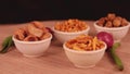 Shing bhujia and chanadal with bhakharvadi on wooden table,Indian Namkeen indian food in white bowl in white background,Namkeen in