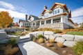 shingle style mansion with stonewalled landscaping