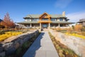 shingle style mansion with stonewalled landscaping