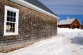 A shingled wooden barn in winter