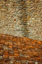 Shingles on roof covered by lichens and stone wall Royalty Free Stock Photo