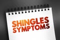 Shingles Symptoms - viral infection that causes a painful rash, medical text concept on notepad