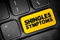 Shingles Symptoms - viral infection that causes a painful rash, text button on keyboard, concept background