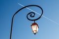Shining Backlit Streetlamp and Airplane Trail Royalty Free Stock Photo