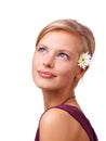 Shining beauty. Studio shot of a beautiful young woman with a flower in her hair isolated on white.