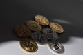 shining bitcoins and ether coins from cryptocurrency in a shadow