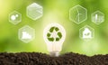 Shining bulb with recycle icon and energy resource icons as a symbol of renewable, alternative or sustainable energy source. Royalty Free Stock Photo