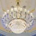 Shining chandelier hanging on a ceiling in hotel