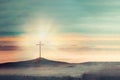 Shining cross on Calvary hill, sunrise, sunset sky background. Copy space. Ascension day concept. Christian Easter Royalty Free Stock Photo