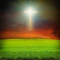 Shining cross over dark sky and field Royalty Free Stock Photo