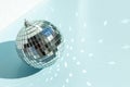 Shining disco ball on blue background. Disco ball with bright rays