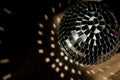 Shining disco ball isolated on wooden floor, shadow tin, bright highlights in shadow from disco ball, fun party concept