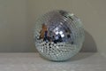 Shining disco ball with a lot of sparkles on table in room as home decor.