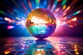 Shining Disco ball in the night club with abstract bokeh colored background