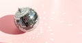 Shining disco ball on pink background. Disco ball with bright rays Royalty Free Stock Photo