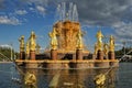 Shining Gold Friendship of Nations Fountain Against Grey Clouds