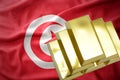 Shining golden bullions on the tunisia flag Royalty Free Stock Photo