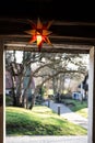 a shining Herrnhuter Star in an entrance at Christmas time as a symbol of peace Royalty Free Stock Photo