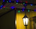 The shining lamp and garland on the house