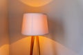 shining lamp on the table near bed.Table lamp dimly shines on the table in the bedroom.Light gleam, shine warm room Royalty Free Stock Photo